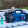cuve-ibc-blanc-pompe-sur-batterie-1000L-nettoye-palette-acier-plastique-vue-de-gauche-devant-sans-tuyau.webp